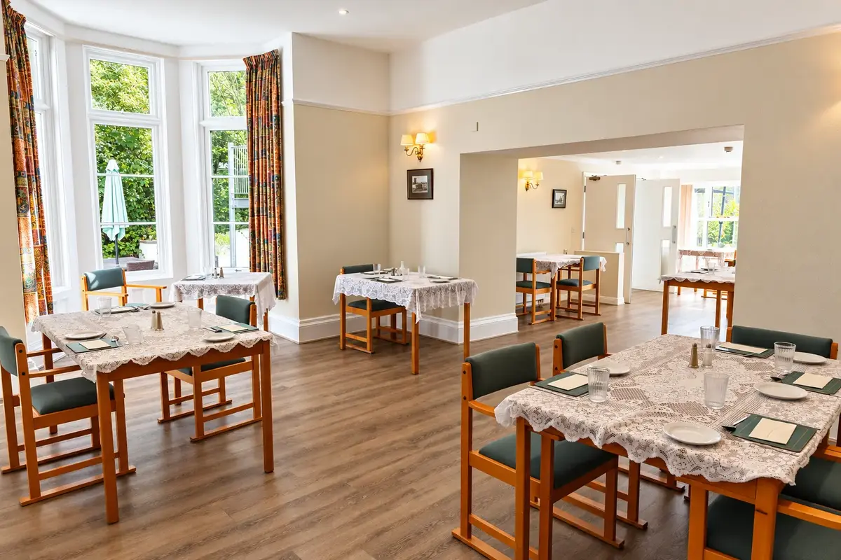The bright Springfields dining room, with tables laid for residents